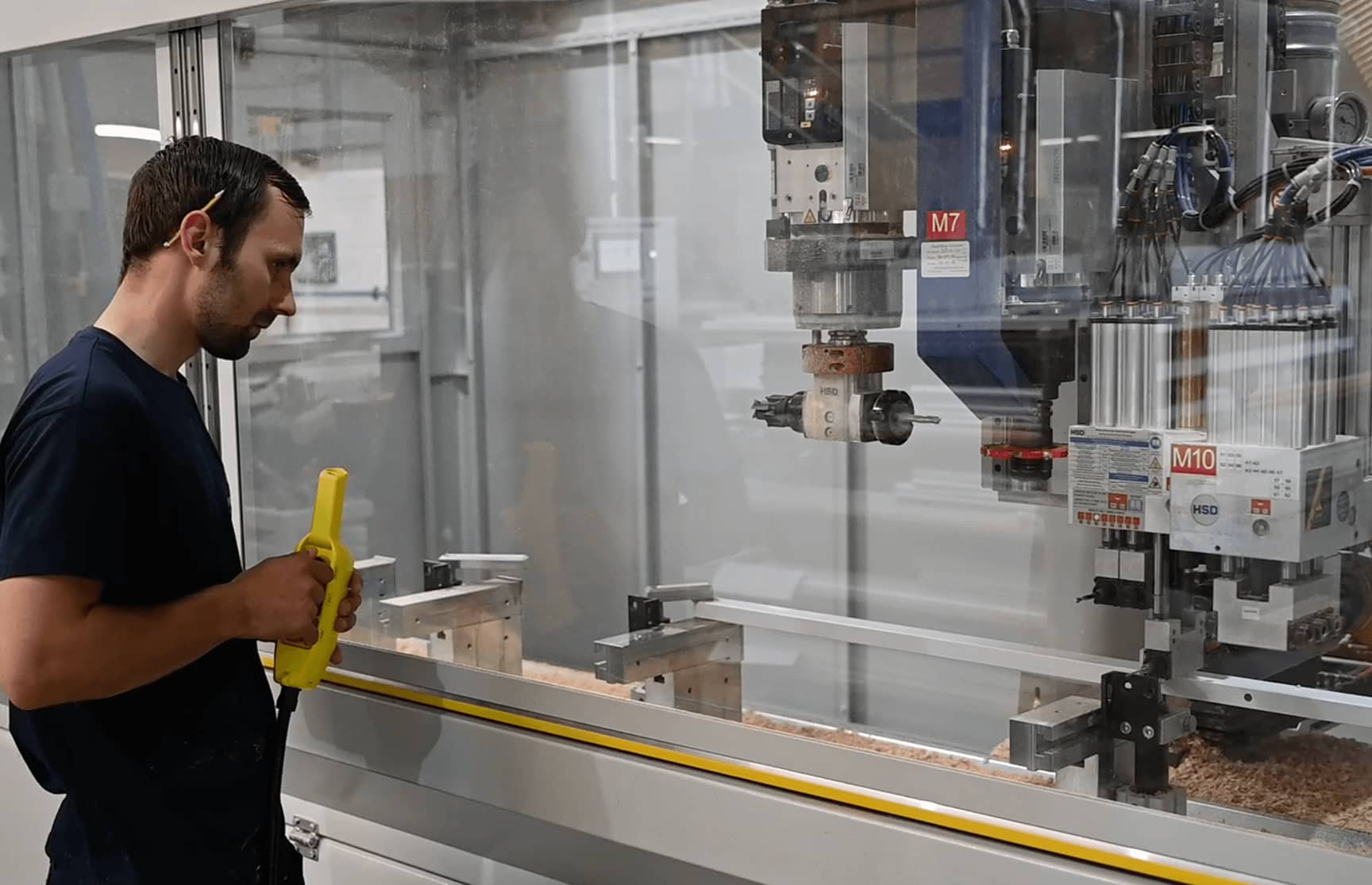 Man standing next to shutter machine