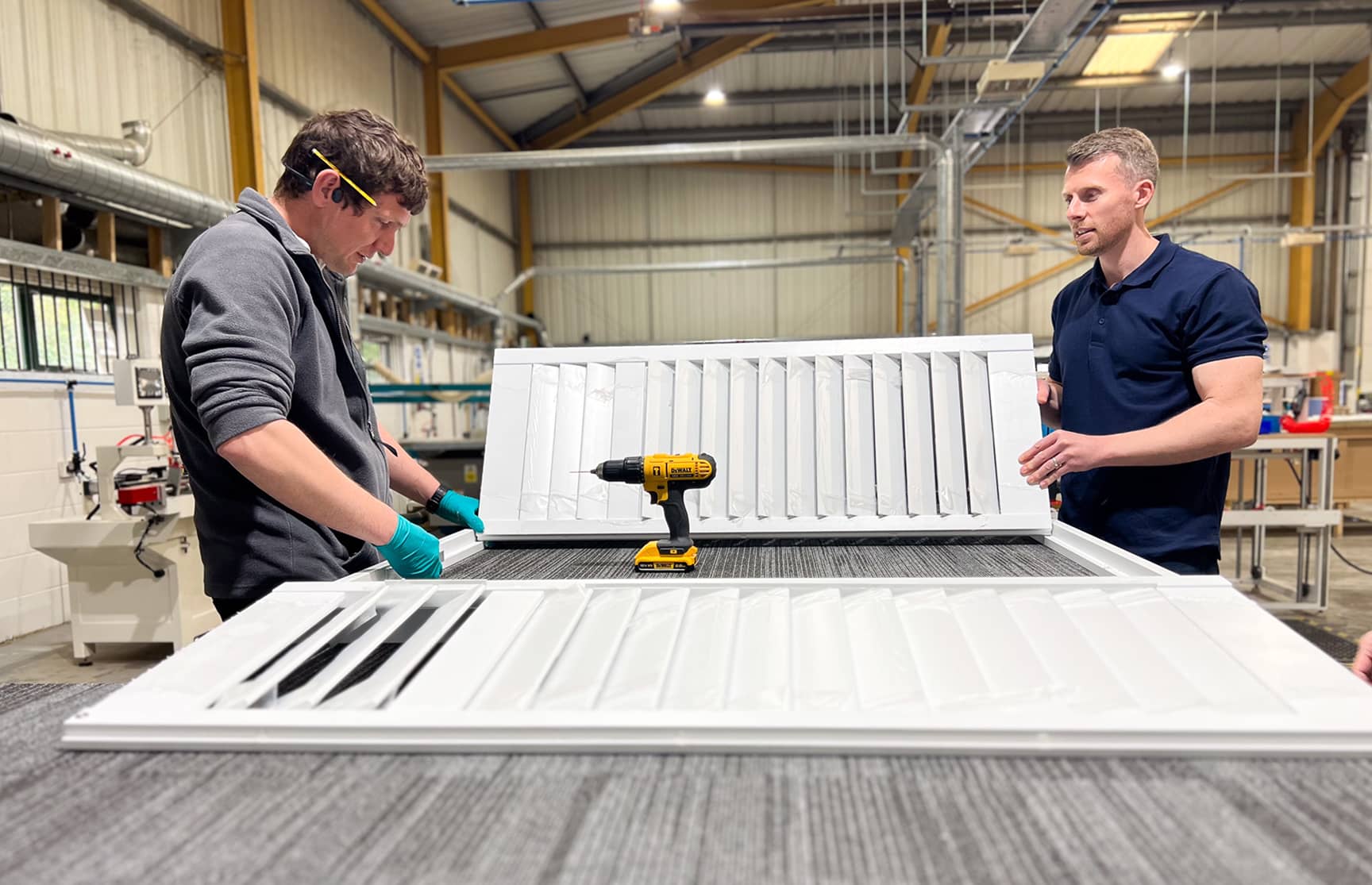 Two people manufacturing shutters