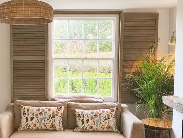 Premium hardwood shutters installed in a farmhouse